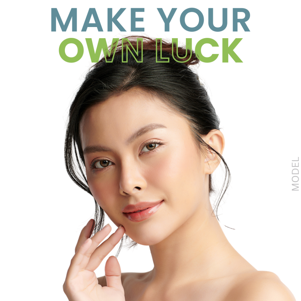 A woman touching her face (model) with text that reads "Make Your Own Luck"