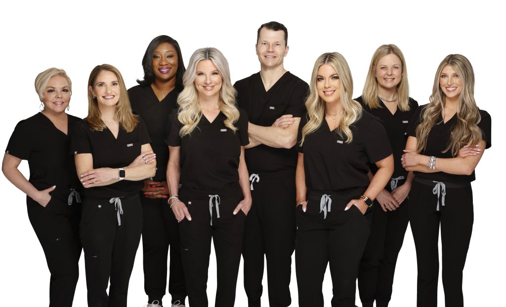 Group photo of the team at Wright Plastic Surgery and Med Spa in black scrubs