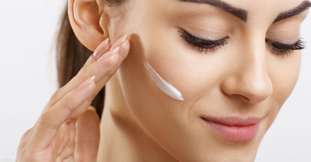 Woman applying skincare